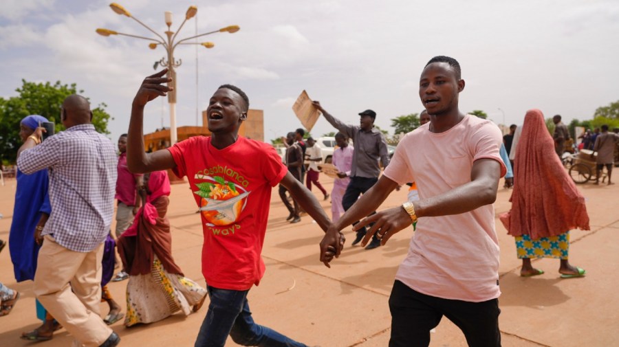 File - Supporters of Niger's ruling junta cheer in Niamey, Niger, Sunday, Aug. 6, 2023.