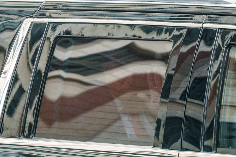 Former President Trump waves as he leaves the E. Barrett Prettyman United States District Court House