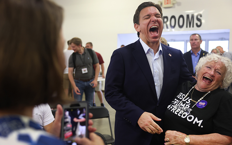 Florida Gov. Ron DeSantis and a guest at Ashley's BBQ Bash laugh