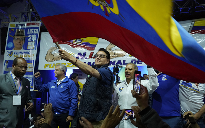 Presidential candidate Fernando Villavicencio waves an Ecuadorian flag during a campaign event