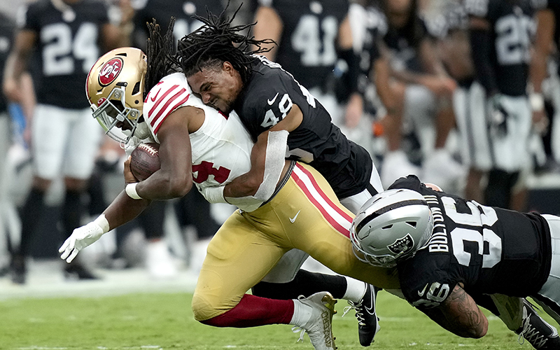 Las Vegas Raiders cornerback Azizi Hearn loses his helmet as he tackles San Francisco 49ers running back Jordan Mason