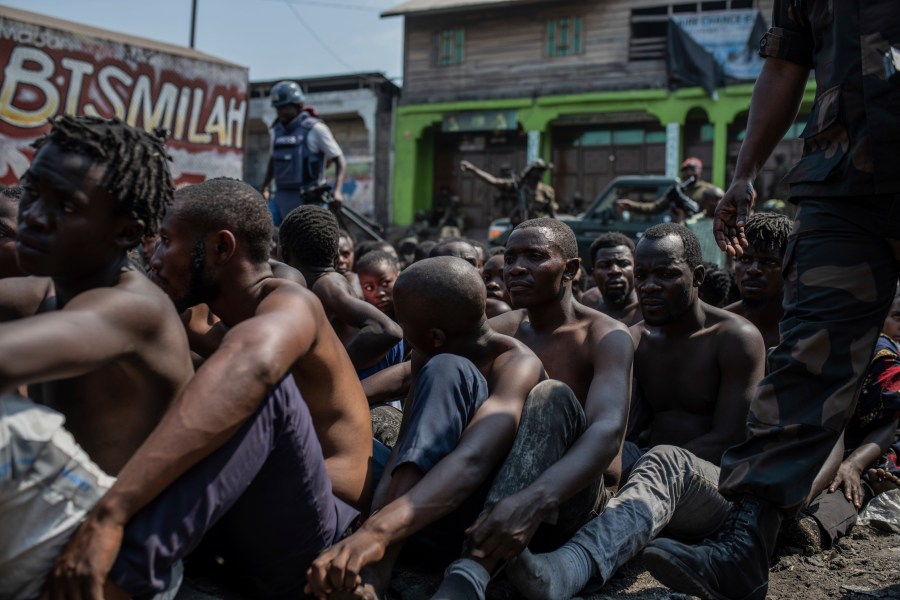 Arrested members of the Wazalendo sect are sat and lined up in Goma, Democratic Republic of the Congo, Wednesday, Aug. 30, 2023.