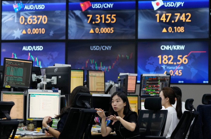 Currency traders work at the foreign exchange dealing room of the KEB Hana Bank headquarters in Seoul, South Korea, Thursday, Sept. 7, 2023. Shares fell in Asia on Thursday after a decline on Wall Street, where strong economic data revived worries that the Federal Reserve might keep interest rates high for longer than hoped. (AP Photo/Ahn Young-joon)