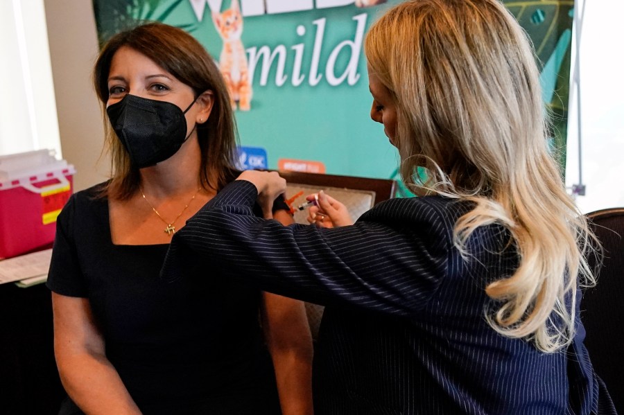 FILE - Dr. Mandy Cohen, director of the Centers for Disease Control and Prevention, receives a flu vaccine from Nurse Practitioner Whitney Goggans at the Atlanta Press Club, where Cohen spoke about health issues, Wednesday, Sept. 6, 2023, in Atlanta. Cohen says the U.S. is in “our strongest position yet” to avoid another chaotic respiratory season. “There will be a lot of virus this winter. That’s why we want to get ahead of it.” (AP Photo/Mike Stewart, File)