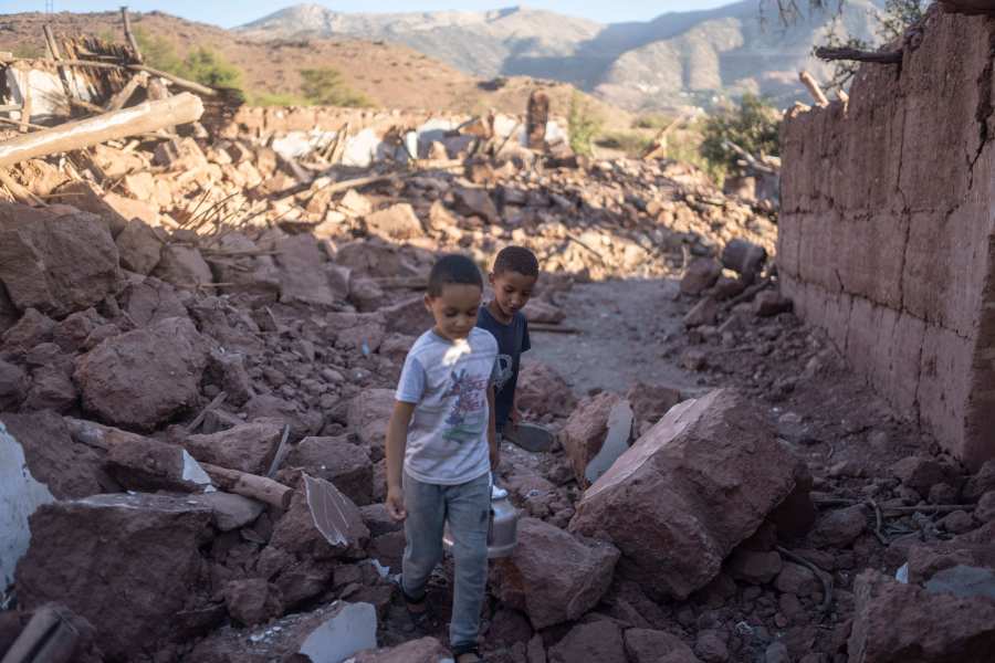 Moroccan boys, Rayan and Ali walk amidst the rubble of their home which was damaged by the earthquake, in Ijjoukak village, near Marrakech, Morocco, Saturday, Sept. 9, 2023. A rare, powerful earthquake struck Morocco, sending people racing from their beds into the streets and toppling buildings in mountainous villages and ancient cities not built to withstand such force. (AP Photo/Mosa'ab Elshamy)