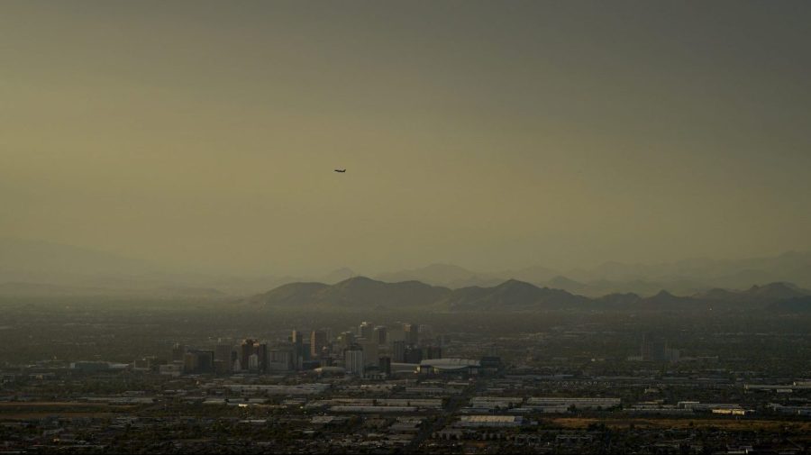 Clouds surround downtown Phoenix at sunset, Sunday, July 30, 2023. The city so far this year has seen 52 days of highs at 110 degrees or over and is expected to hit that mark again on both Saturday, Sept. 9, and Sunday. (AP Photo/Matt York)