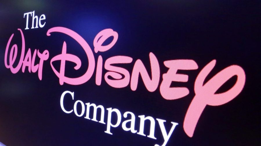 FILE - The Walt Disney Co. logo appears on a screen above the floor of the New York Stock Exchange, Aug. 7, 2017, in New York. Hours before the fall's first “Monday Night Football” game, Disney and Charter Communications have settled a business dispute that had left some 15 million cable TV customers without ESPN and other Disney channels. Disney said that because of the deal, the majority of its ESPN customers would have service restored to Charter's Spectrum cable system right away. Charter confirmed the deal Monday, Sept. 11, 2023. (AP Photo/Richard Drew, File)