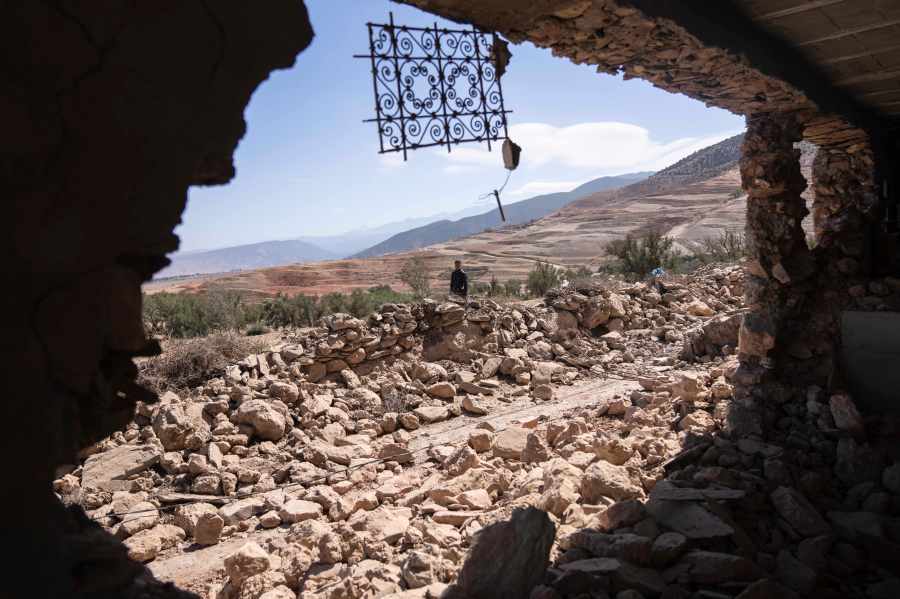 A man walks past rubble caused by the earthquake in the village of Tafeghaghte, near Marrakech, Morocco, Monday, Sept. 11, 2023. Rescue crews expanded their efforts on Monday as the earthquake's death toll continued to climb to more than 2,400 and displaced people worried about where to find shelter. (AP Photo/Mosa'ab Elshamy)