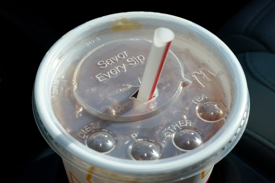 FILE - A McDonald's beverage sits in a cup holder, April 27, 2021, in Des Moines, Iowa. McDonald's plans to eliminate self-service soda machines at all of its U.S. restaurants by 2032, the Chicago-based fast food chain has confirmed. In an email to The Associated Press on Tuesday, Sept. 12, 2023, McDonald's USA said the goal of the change is to create consistency for customers and crew members across the chain's offerings — from in-person dining to online delivery and drive-thru options. (AP Photo/Charlie Neibergall, File)