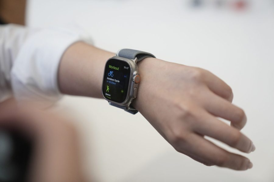 A person tries on an Apple Watch during an announcement of new products on the Apple campus, Tuesday, Sept. 12, 2023, in Cupertino, Calif. (AP Photo/Jeff Chiu)