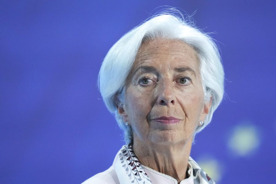 Christine Lagarde is seen in front of a blue backdrop.