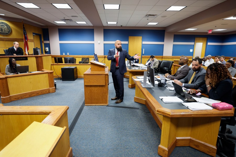 Attorney Scott Grubman, who is defending Kenneth Chesebro, speaks before Fulton County Superior Court Judge Scott McAfee, left, in Atlanta on Thursday, Sept. 14, 2023. Donald Trump will not face trial next month in Georgia after McAfee ruled Thursday that the former president and 16 others accused of illegally trying to overturn the results of the 2020 election will be tried separately from two lawyers in the case. Lawyers Sidney Powell and Chesebro had filed demands for a speedy trial, and McAfee set their trial to begin Oct. 23. (Miguel Martinez/Atlanta Journal-Constitution via AP, Pool)