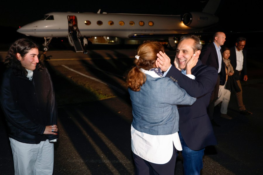 Family members embrace freed American Emad Shargi after he and four fellow detainees were released in a prisoner swap deal between U.S and Iran, as he arrives at Davison Army Airfield, Tuesday, Sept. 19, 2023 at Fort Belvoir, Va. (Jonathan Ernst/Pool via AP)