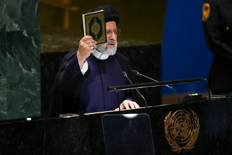 Iran’s President Ebrahim Raisi holds a Quran as he addresses the 78th session of the United Nations General Assembly at United Nations headquarters, Tuesday, Sept. 19, 2023. (AP Photo/Seth Wenig)