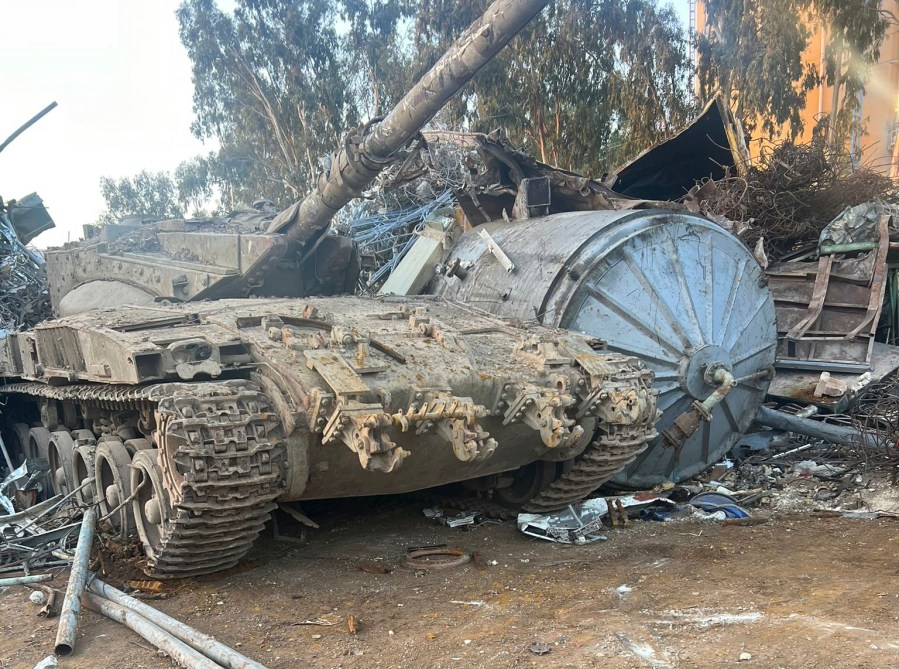 In this photo provided by the Israeli police, an Israeli tank that was stolen from a military zone is seen in a junkyard near Haifa, Israel, Wednesday, Sept. 20, 2022. Israeli authorities are trying to figure out how the tank was stolen from a military training zone and taken to the junkyard in northern Israel. The army said that the tank was unarmed and had been out of service for many years. (Israeli Police via AP)