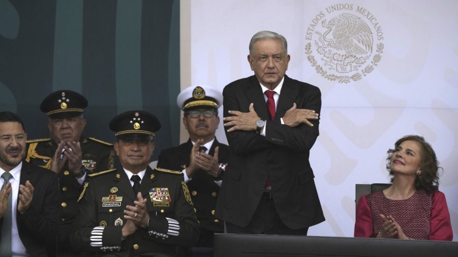 Mexico's President Andrés Manuel López Obrador, accompanied by first lady Beatriz Gutiérrez Müller, sends out a symbolical embrace at the start of the annual Independence Day parade in the capital's main square, the Zocalo, in Mexico City, Saturday, Sept. 16, 2023. (AP Photo/Fernando Llano)