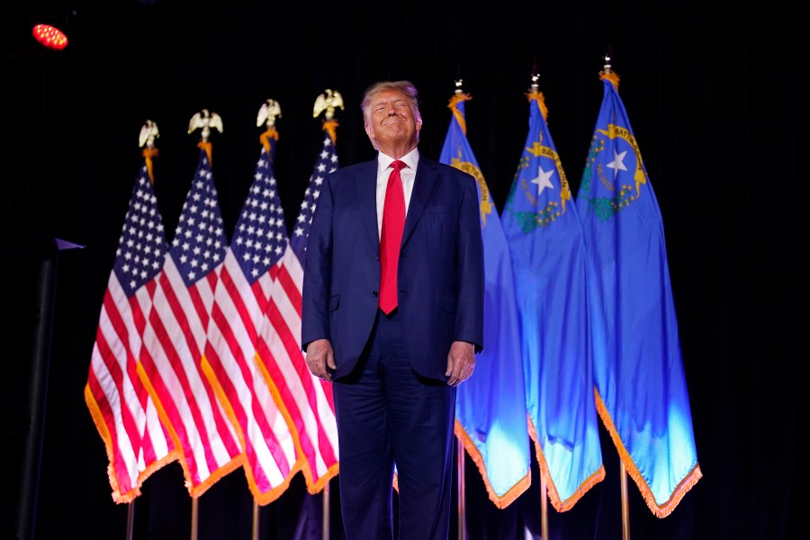 FILE - Former President Donald Trump stands on stage before speaking at a campaign event, July 8, 2023, in Las Vegas. Trump's push to bend state Republican parties to his will, and gain an advantage in his effort to return to the White House, is coming to a head in Nevada. (AP Photo/John Locher, File)