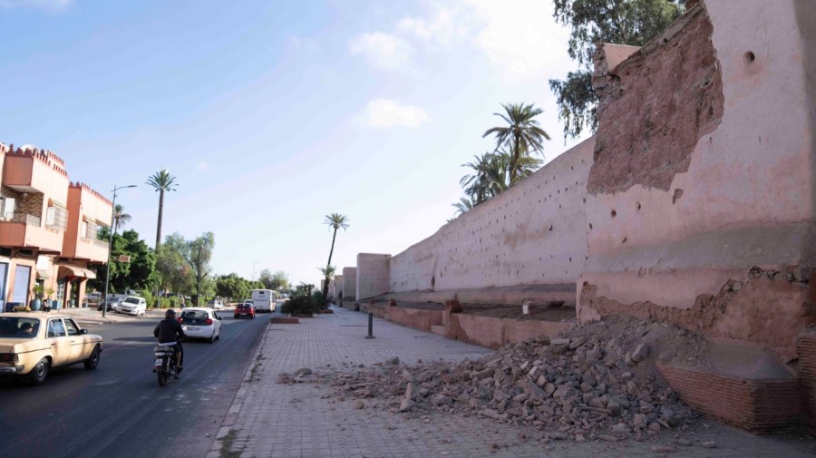 People drive past a damaged wall of the historic Medina of Marrakech, after after an earthquake in Morocco, Saturday, Sept. 9, 2023. A rare, powerful earthquake struck Morocco late Friday night, killing more than 600 people and damaging buildings from villages in the Atlas Mountains to the historic city of Marrakech.