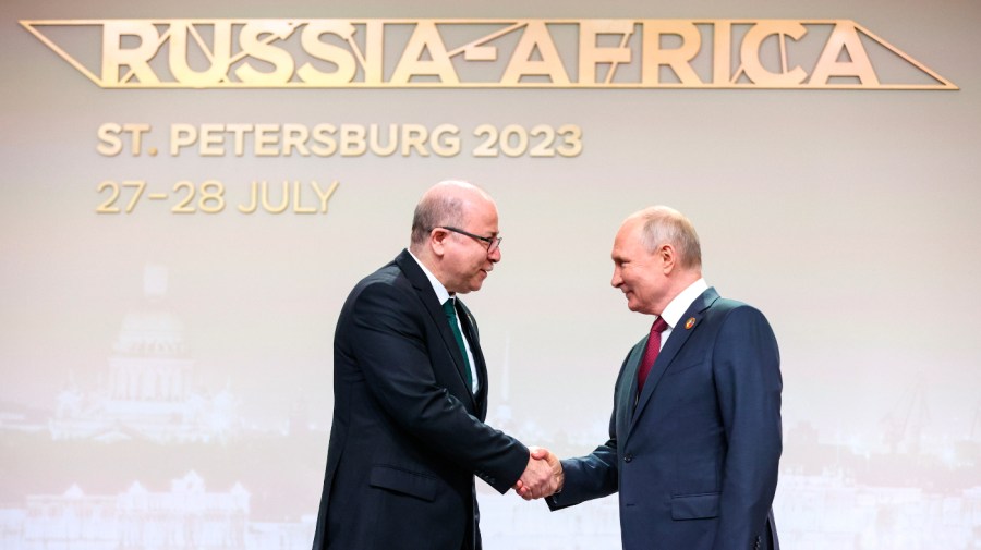 Algerian Prime Minister Aymen Benabderrahmane, left, and Russian President Vladimir Putin shake hands before an official ceremony to welcome the leaders of delegations to the Russia Africa Summit in St. Petersburg, Russia.