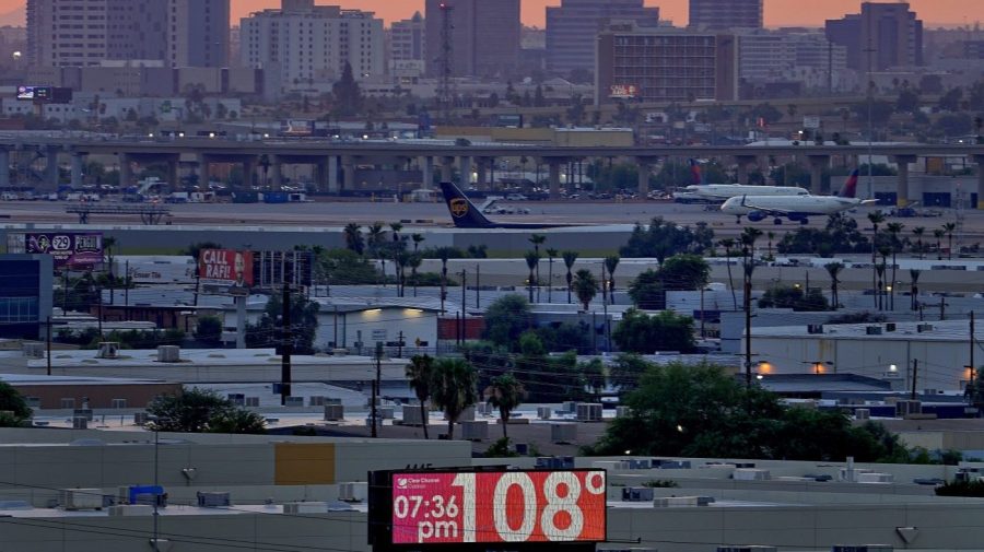 FILE - A sign displays an unofficial temperature as jets taxi at Sky Harbor International Airport at dusk, July 12, 2023, in Phoenix. Phoenix, Arizona’s most populous city, is in the record books again for notching a record for dry heat. The National Weather Service said Sunday, Oct 1, that the monsoon season this year in the arid Southwest dropped only 0.15 inches (.38 centimeters) of rainfall from June 15 to Sept. 30. That’s the driest since the agency began keeping records in 1895. (AP Photo/Matt York, File)