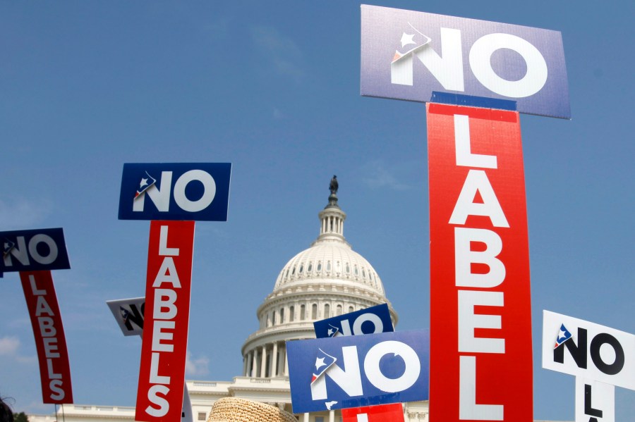 FILE - People with the group No Labels hold signs during a rally on Capitol Hill in Washington, July 18, 2011. More than 15,000 people in Arizona have registered to join a new political party floating a possible bipartisan “unity ticket” against Joe Biden and Donald Trump. (AP Photo/Jacquelyn Martin, File)