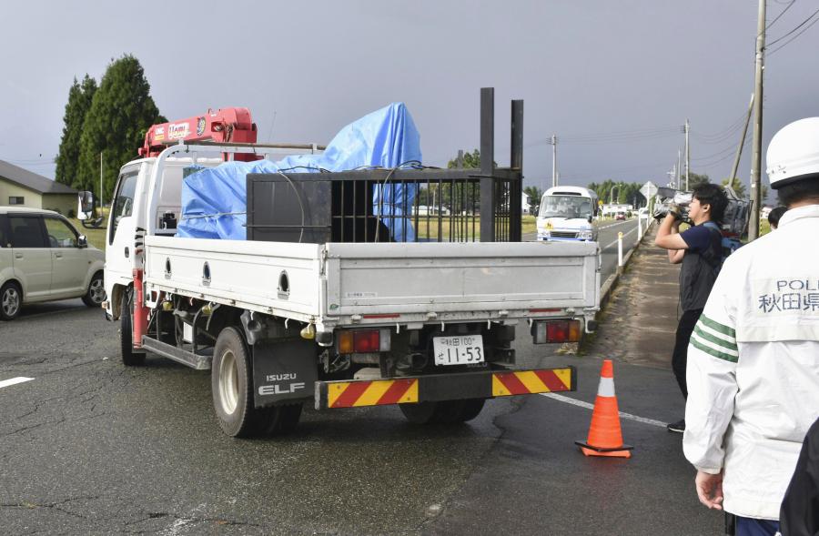 Bears at cages placed on a truck are taken out of a factory in Misato, Akita prefecture, Thursday, Oct. 5, 2023. The bears, believed to be a parent and two cubs, were spotted by a patrolling town official as they walked into a tatami factory Wednesday morning in the Misato town. On Thursday morning, the bears were trapped in cages, two cubs in one and the adult in another. (Kyodo News via AP)