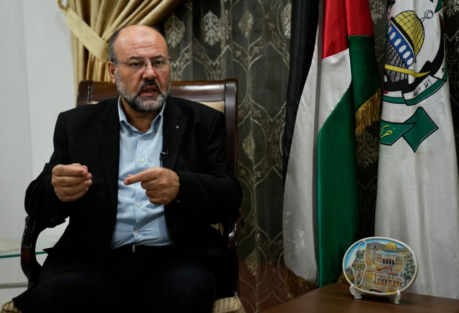 Ali Barakeh, a member of Hamas’ exiled leadership, speaks during an interview with The Associated Press in Beirut, Lebanon, Monday, Oct. 9, 2023. Barakeh on Monday denied that Iran or the Lebanese Hezbollah had helped plan or were even aware of the wide-ranging incursion his group launched into Israel, but said “our allies will join the battle if Gaza is subjected to a war of annihilation.” (AP Photo/Hussein Malla)