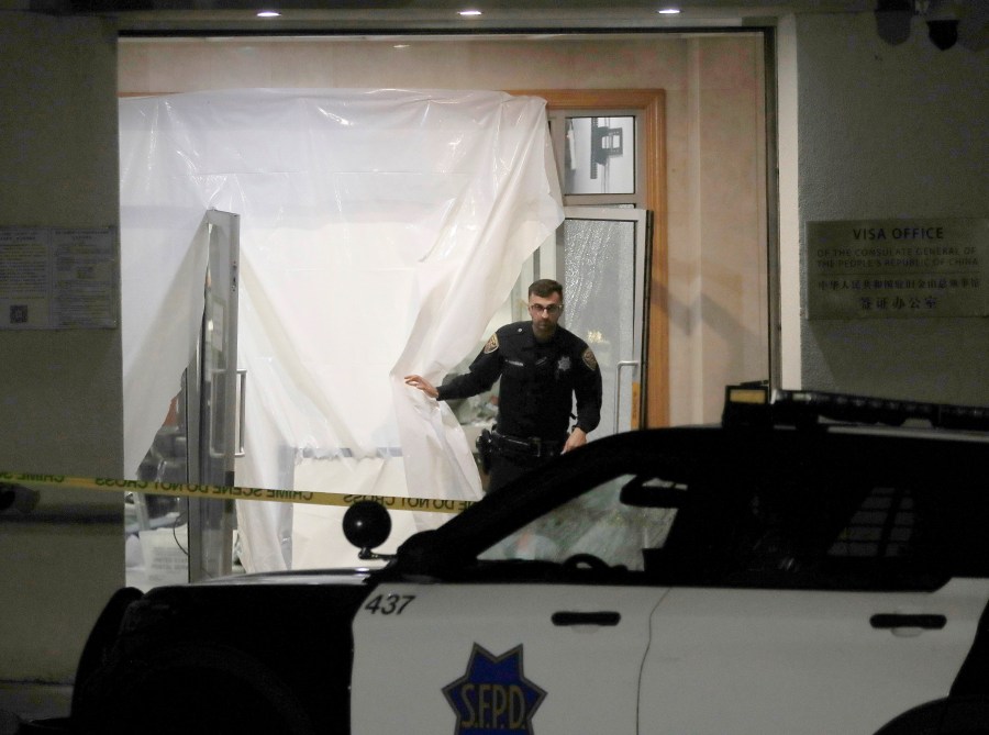 San Francisco police investigate at the Chinese consulate in San Francisco on Monday, Oct. 9, 2023. Officials said a car rammed into the consulate building Monday, coming to a stop in the lobby and creating a chaotic scene that ended with police shooting the driver, who later died at the hospital. (Jane Tyska/Bay Area News Group via AP)