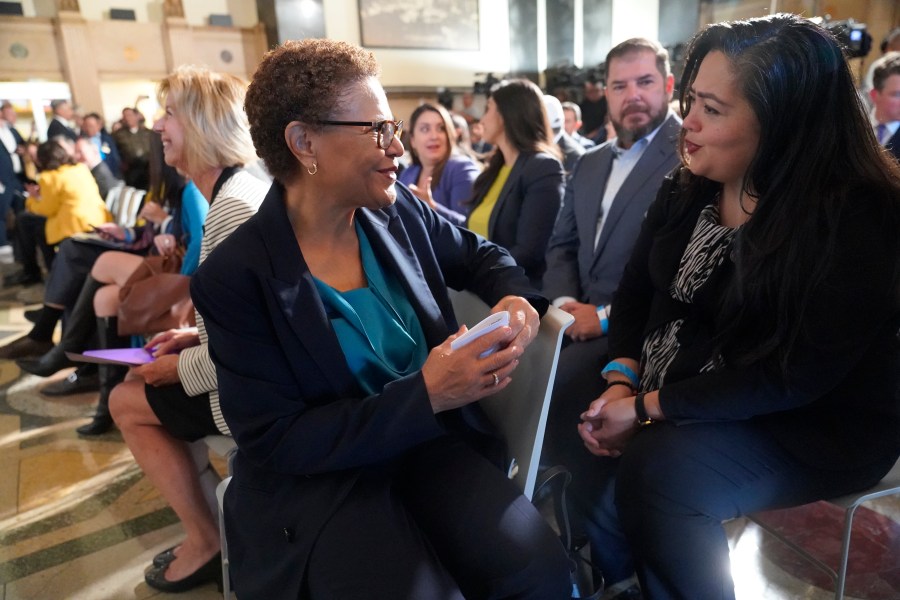 Los Angeles Mayor Karen Bass, left, talks with Assembly member Wendy Carrillo as they attend a ceremony after California Gov. Gavin Newsom signed off on two major pieces of legislation, Thursday, Oct. 12, 2023, in Los Angeles, to transform the state's mental health system and address the state's worsening homelessness crisis, putting them both before voters in 2024. (AP Photo/Damian Dovarganes)