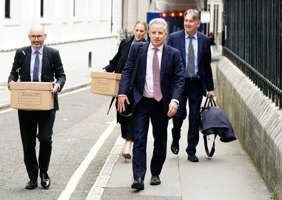 Christopher Steele , foreground right, leaves the Royal Courts of Justice after the first hearing in Donald Trump's High Court claim against the former MI6 officer's intelligence consultancy, in London. Monday, Oct. 16, 2023. A lawyer for Donald Trump has told a London judge that the ex-president plans to prove that a “shocking and scandalous” report by a former British spy was wrong and harmed his reputation. Trump has sued the company founded by Christopher Steele, who created a dossier in 2016 that contained rumors and uncorroborated allegations about Trump that erupted in a political storm just before his inauguration. (Aaron Chown/PA ia AP)