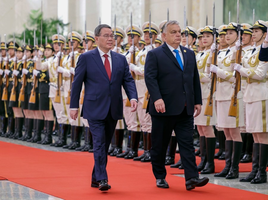 FILE- In this photo released by Xinhua News Agency, visiting Hungarian Prime Minister Viktor Orban, right, and his Chinese counterpart Li Qiang review an honor guard during a welcome ceremony at the Great Hall of the People in Beijing, on Oct. 16, 2023. Hungarian Prime Minister Viktor Orban is the only head of state or government from the European Union to attend the Belt and Road forum. Hungarian media reports last month suggested a Chinese-backed railway project connecting Budapest with Belgrade has hit snags and China would halt funding. (Liu Bin/Xinhua via AP, File)