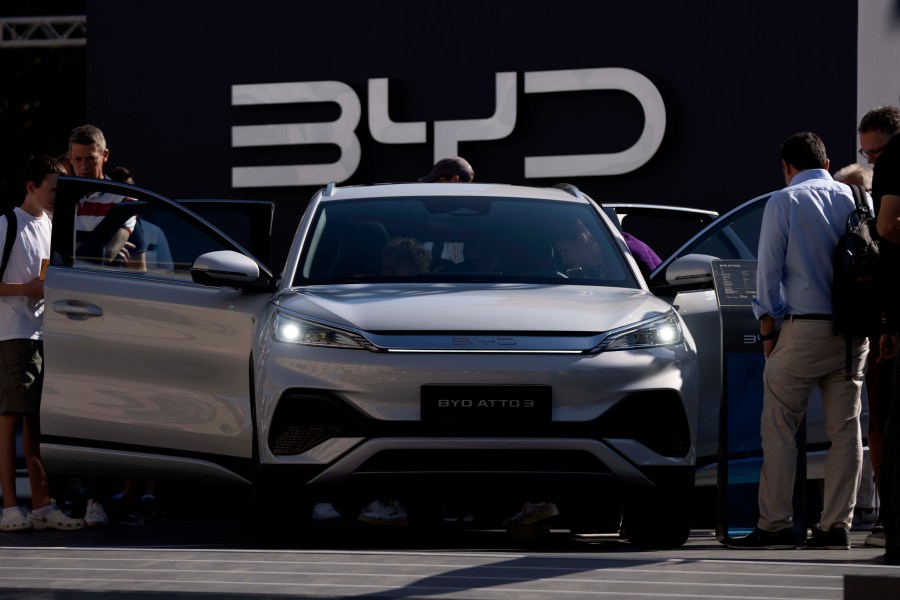 File - Visitors watch the BYD ATTO 3 at the IAA motor show in Munich, Germany, Friday, Sept. 8, 2023. The international motor show IAA Mobility 2023 takes place in Munich from Sept. 5 until Sept. 10, 2023. Chinese automakers are winning over drivers as they make major inroads into Europe’s electric vehicle market, challenging long-established homegrown brands in an industry that’s key to the continent’s green energy transition. The European Union has launched an investigation into Beijing’s support for its EV industry, adding to tensions between the West and China. (AP Photo/Matthias Schrader, File)