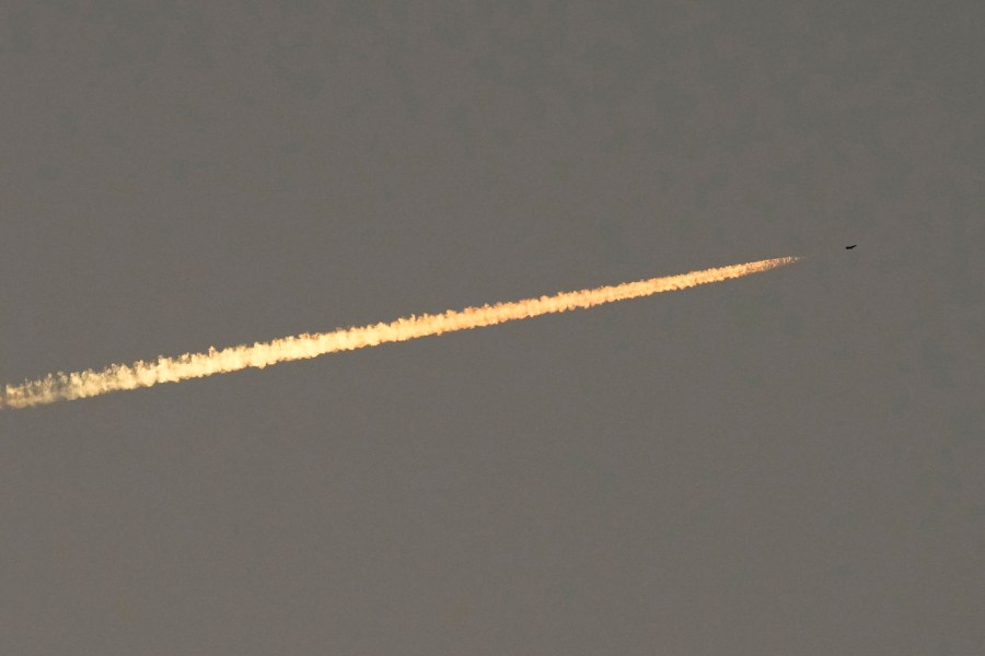 An Israel war plane flies over Lebanon as the sun sets over Tair Harfa village, a Lebanese border village with Israel, south Lebanon, Friday, Oct. 20, 2023. (AP Photo/Hassan Ammar)