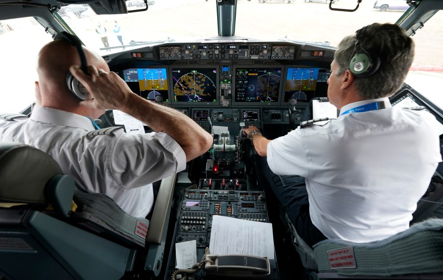 File - Pilots conduct a pre-flight check in the cockpit of a jet before taking off from Dallas Fort Worth airport in Grapevine, Texas, on Dec. 2, 2020. Aviation experts say the incident on Sunday in which an off-duty pilot, riding in a jump seat in a cockpit, tried to disable a jetliner in midflight renews questions about the threat posed by airline workers who have special access to places where passengers can't go. (AP Photo/LM Otero, File)