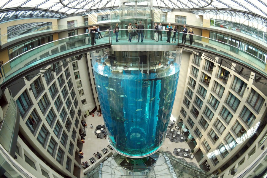 FILE - People gather on the top of the AquaDom aquarium at the Sea Life tourist attraction in Berlin, on July 27, 2015. Prosecutors in Berlin say they have closed their investigation into the spectacular collapse of a huge aquarium last December after an expert report failed to pin down a reason why the tank burst. The AquaDom aquarium, which stood in a hotel lobby, burst in the early hours of Dec. 16, sending 1 million liters (264,000 gallons) of water gushing into the building and the street outside. (Joerg Carstensen via DPA, File)