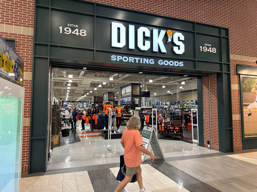 File - A shopper passes a Dick's Sporting Goods store on Aug. 24, 2023, in a shopping center in Lakewood, Colo. On Tuesday, the Conference Board reports on U.S. consumer confidence for October. (AP Photo/David Zalubowski, File)