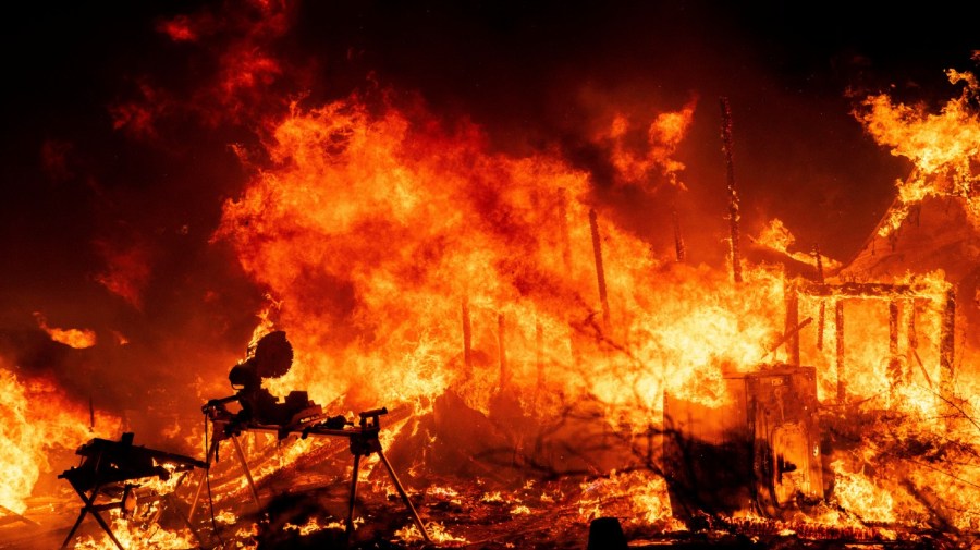 A structure is engulfed in flames as a wildfire called the Highland Fire burns in Aguanga, Calif., Monday, Oct. 30, 2023.