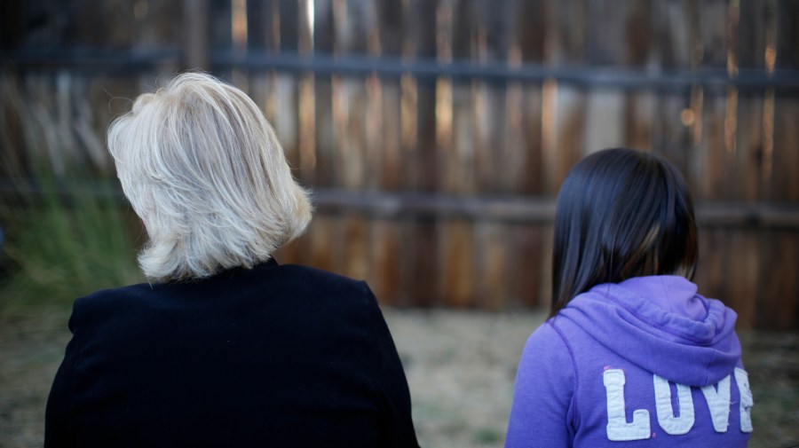 MJ and her adoptive mother sit for an interview in Sierra Vista, Ariz., Oct. 27, 2021. State authorities placed MJ in foster care after learning that her father, the late Paul Adams, sexually assaulted her and posted video of the assaults on the Internet.