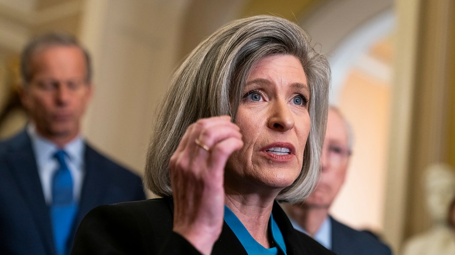 Senator Joni Ernst gestures while speaking.