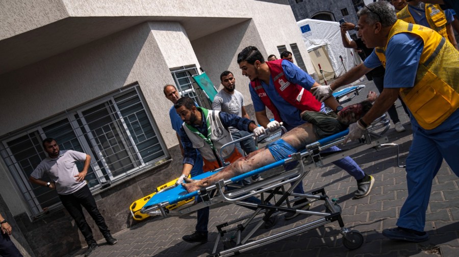 A person injured in an Israeli bombing is brought to a hospital in Gaza City on Wednesday, Oct. 11, 2023.