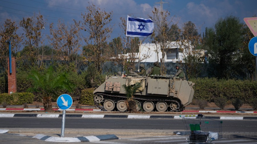 An Israeli armoured personnel carrier (APC) moves on a road towards the Gaza Strip border in southern Israel Monday, Oct. 16, 2023.