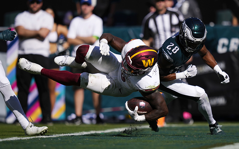 Washington Commanders running back Brian Robinson Jr. scores a touchdown.