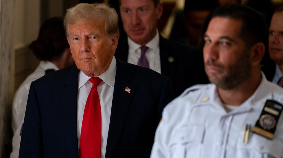 Former President Trump steps out of court during a afternoon break on the third day of his civil fraud trial at New York State Supreme Court on October 04, 2023 in New York City.