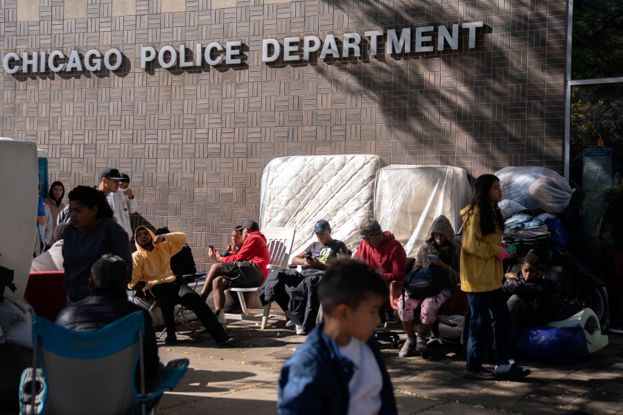 Migrants are camped outside of the 1st District police station, Saturday, Oct. 7, 2023, in Chicago. (AP Photo/Erin Hooley)