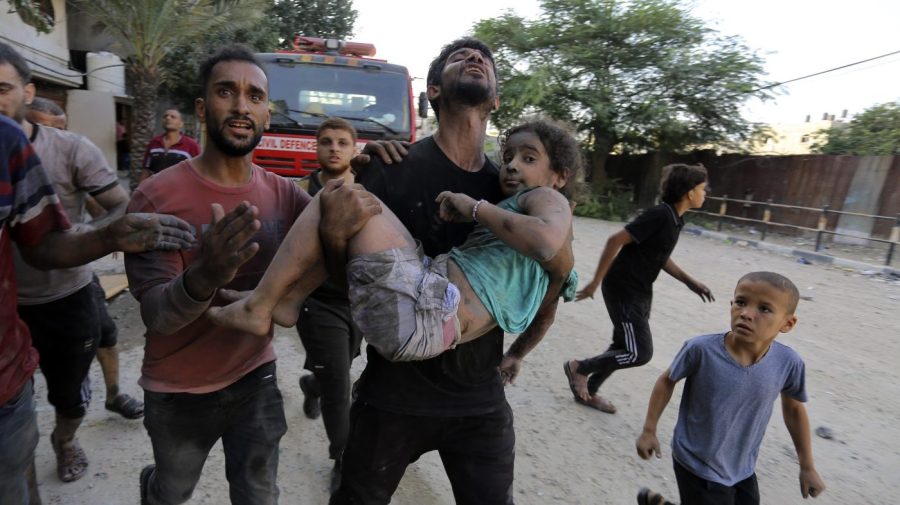 FILE - Palestinians carry a wounded girl after being rescued from under the rubble of buildings that were destroyed by Israeli airstrikes in Jabaliya refugee camp, northern Gaza Strip, Wednesday, Nov. 1, 2023. Weeks after ordering northern Gaza's 1.1 million inhabitants to evacuate south, the Israeli army is intensifying its bombing of the area that stretches to the wetlands of Wadi Gaza. Israeli soldiers are also battling Hamas militants just north of Gaza City. It's the start of what officials expect to be a long and bloody invasion that has already pinned down hundreds of thousands of Palestinians who remain in the north. (AP Photo/Abed Khaled, File)