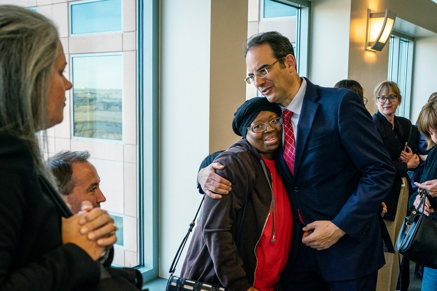 Colorado Attorney General Phil Weiser, right, embraces Sheneen McClain outside a courtroom at the Adams County Justice Center on Monday, Nov. 6, 2023, in Brighton, Colo., as they await word of the jury's verdict over suspended Aurora Police Officer Nathan Woodyard's role in the 2019 death of Elijah McClain. (Hart Van Denburg/Colorado Public Radio via AP)