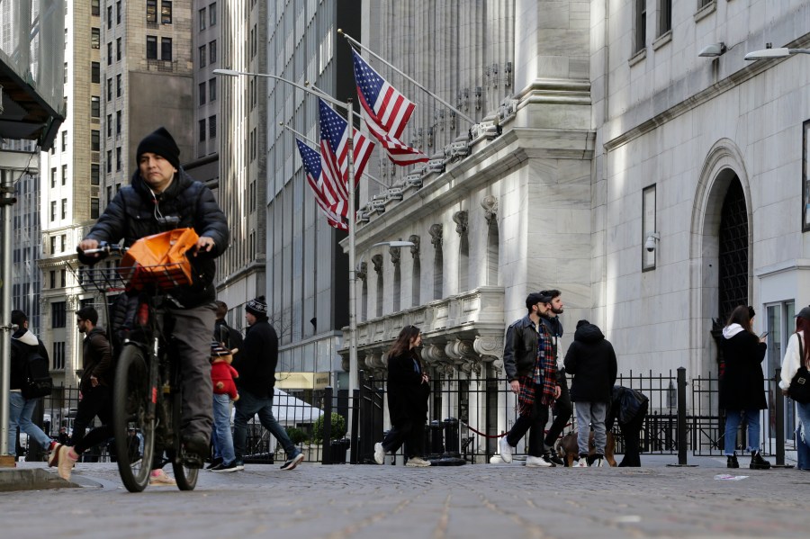 People pass the front of the New York Stock Exchange in New York, Tuesday, March 21, 2023. (AP Photo/Peter Morgan