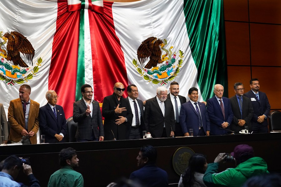 Mexican Journalist Jaime Maussan, center, together with Congressman Sergio Gutierrez Luna and other legislators present what they claim are extraterrestrial life forms on a screen, at the Chamber of Deputies in Mexico City, Tuesday, Nov. 7, 2023. Mexican legislators held another hearing dedicated to the potential for extraterrestrial life forms and UFOs following a controversial spectacle in September in which Maussan displayed what he said were "non-human beings that are not part of our terrestrial evolution." (AP Photo/Marco Ugarte)