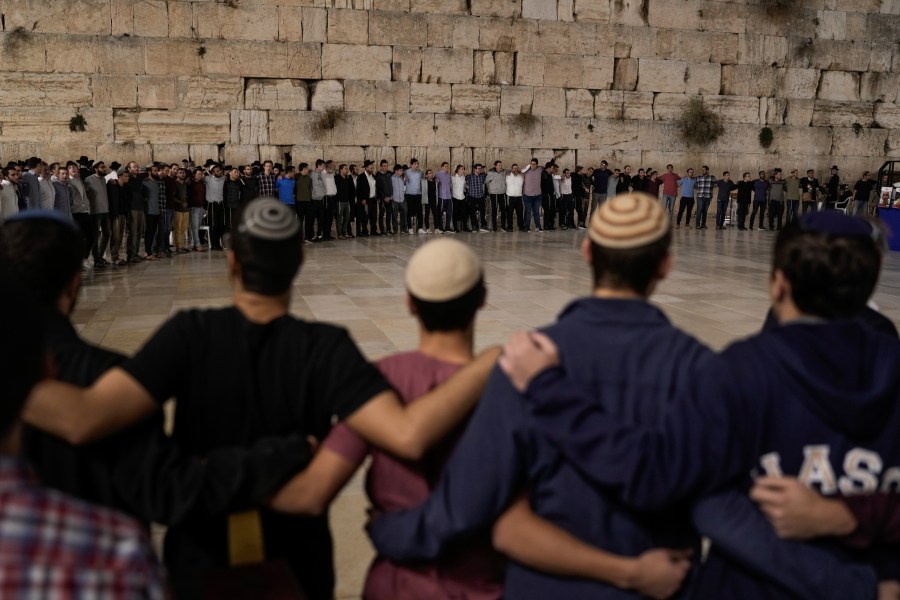 People attend a ceremony to mark the one-month anniversary of the bloody Oct. 7 cross-border attack by Hamas militants, in which 1,400 people were killed and 240 people kidnapped, mostly Israeli citizens, in front of the Western Wall, the holiest site where Jews can pray, in Jerusalem's Old City, Tuesday, Nov. 7, 2023. The cross-border attack by Hamas triggered a war that has raged for the past month. (AP Photo/Leo Correa)