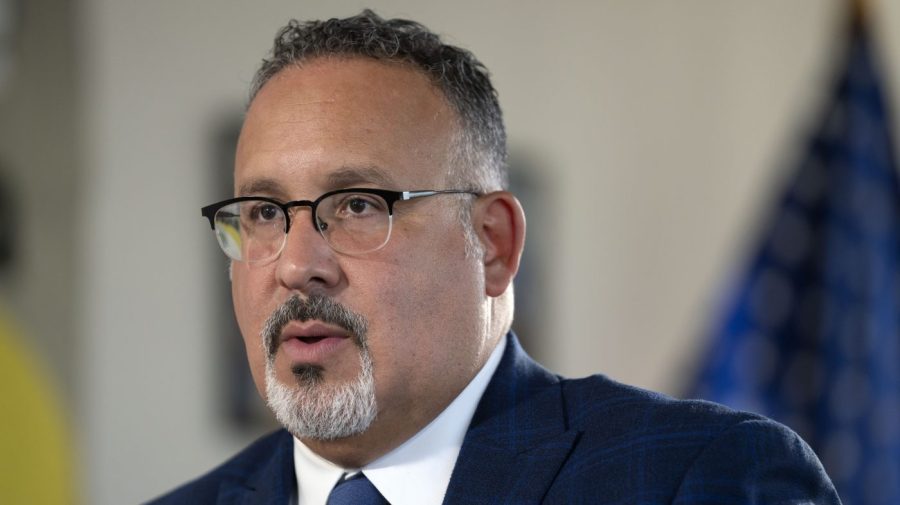 Education Secretary Miguel Cardona speaks during an interview with The Associated Press in his office at the Department of Education.